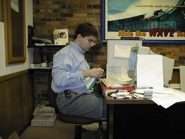 A young Jamie Dolan at his desk in front of a CRT monitor