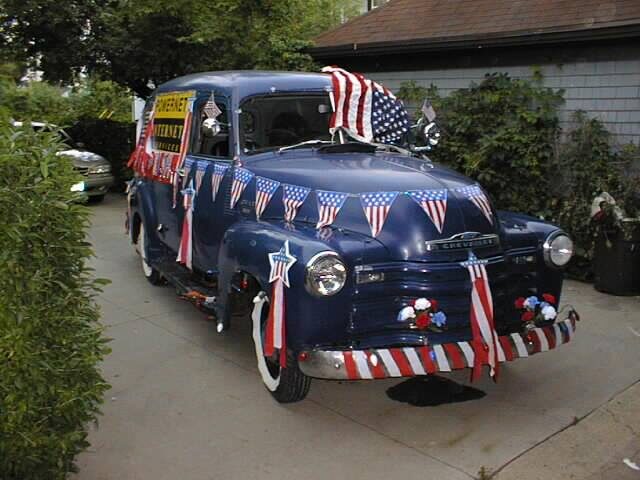 PowerNet's vintage parade truck decorated with flags and bunting