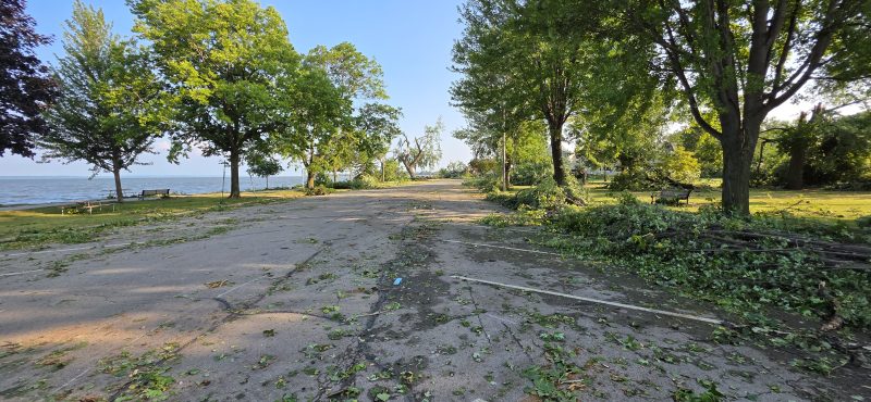 The lakeside drive at Kimberly Point Park strewn with branches and leaves after the storm