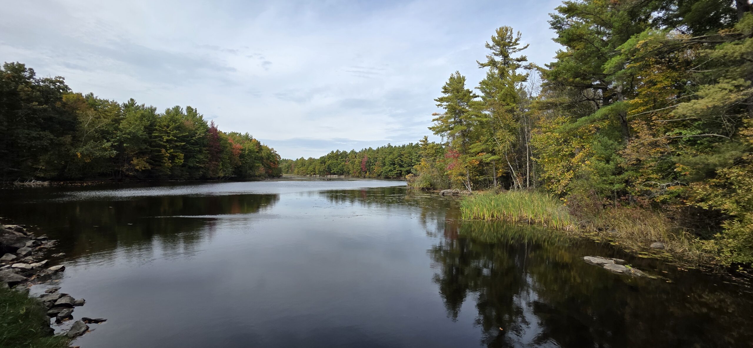 Calm water of Keller Lake stretching away between wooded shores under a cloudy sky.